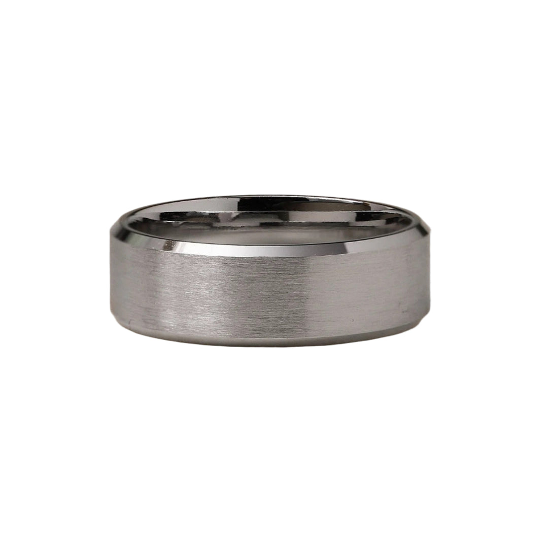 Silver ring with a brushed finish on a beige background