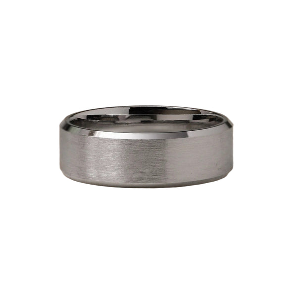 Silver ring with a brushed finish on a beige background